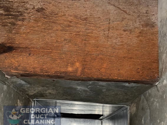 Same wood-framed duct spotless after cleaning